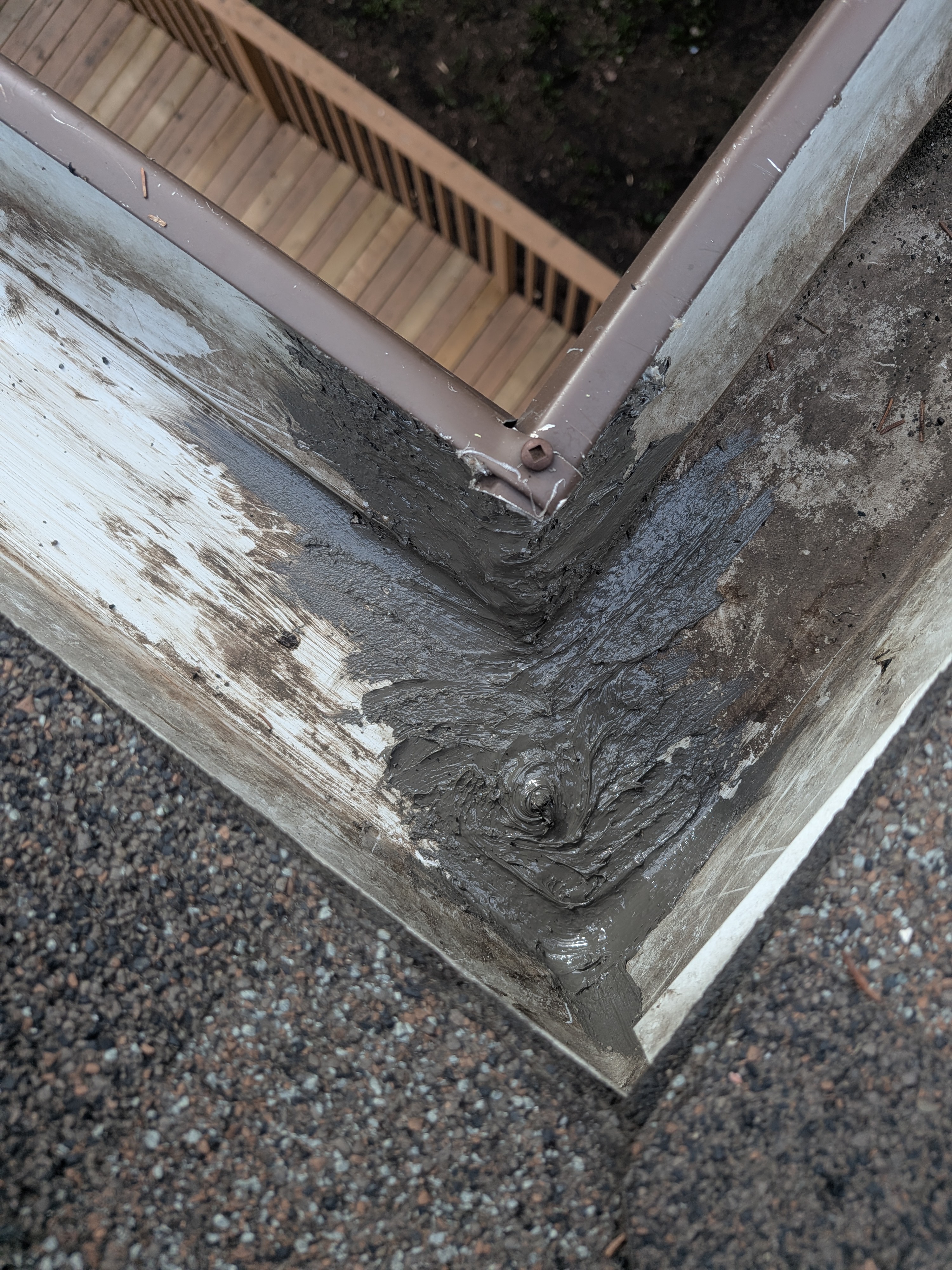 Resealed gutter connection on residential roofline